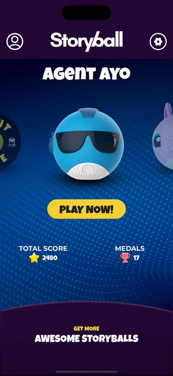 The Storyball home screen showing Agent Ayo, a blue ball in dark sunglasses, with a yellow PLAY NOW button and the total score and medals underneath